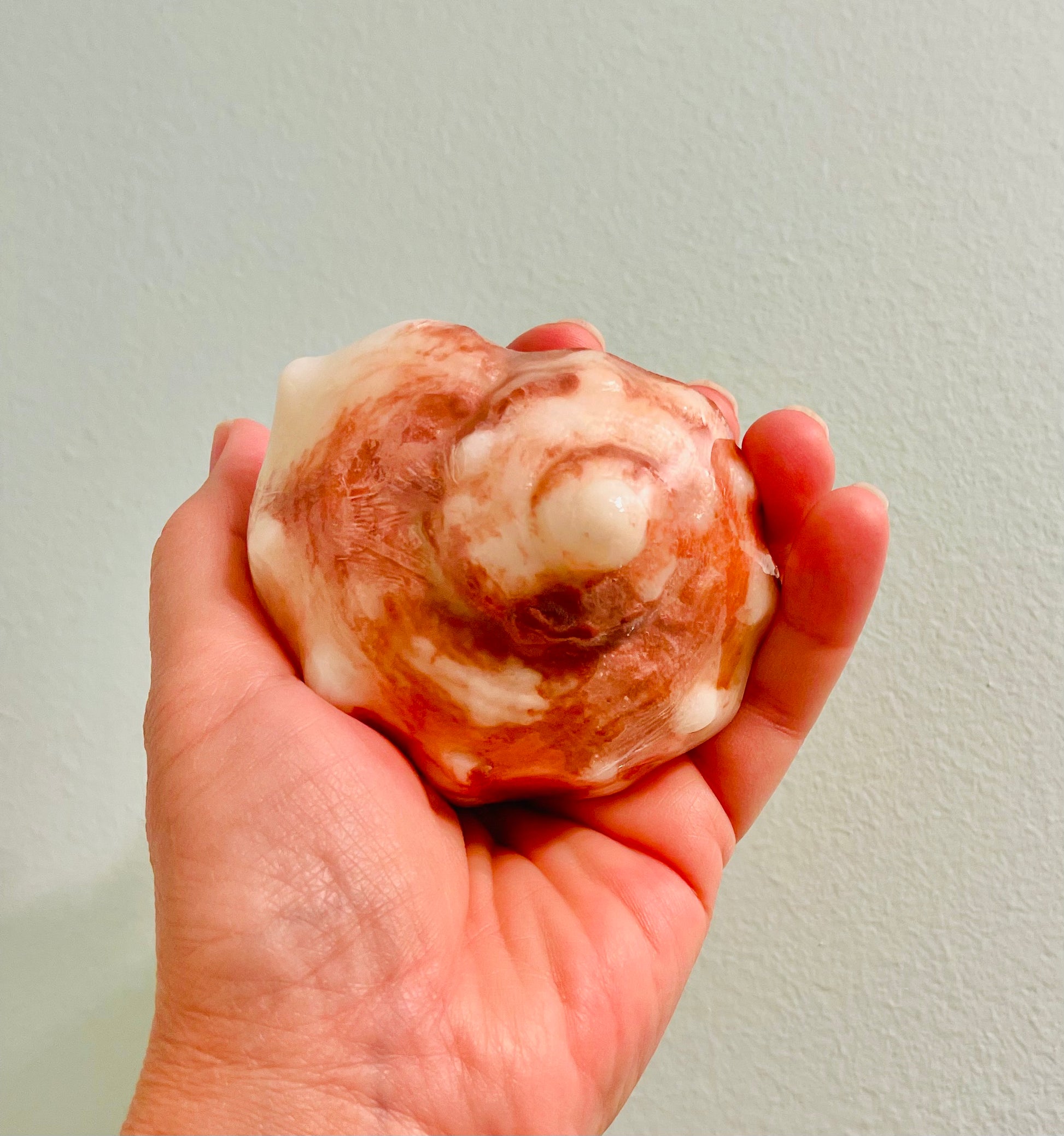 im am holding a conch shell soap with sea sponge