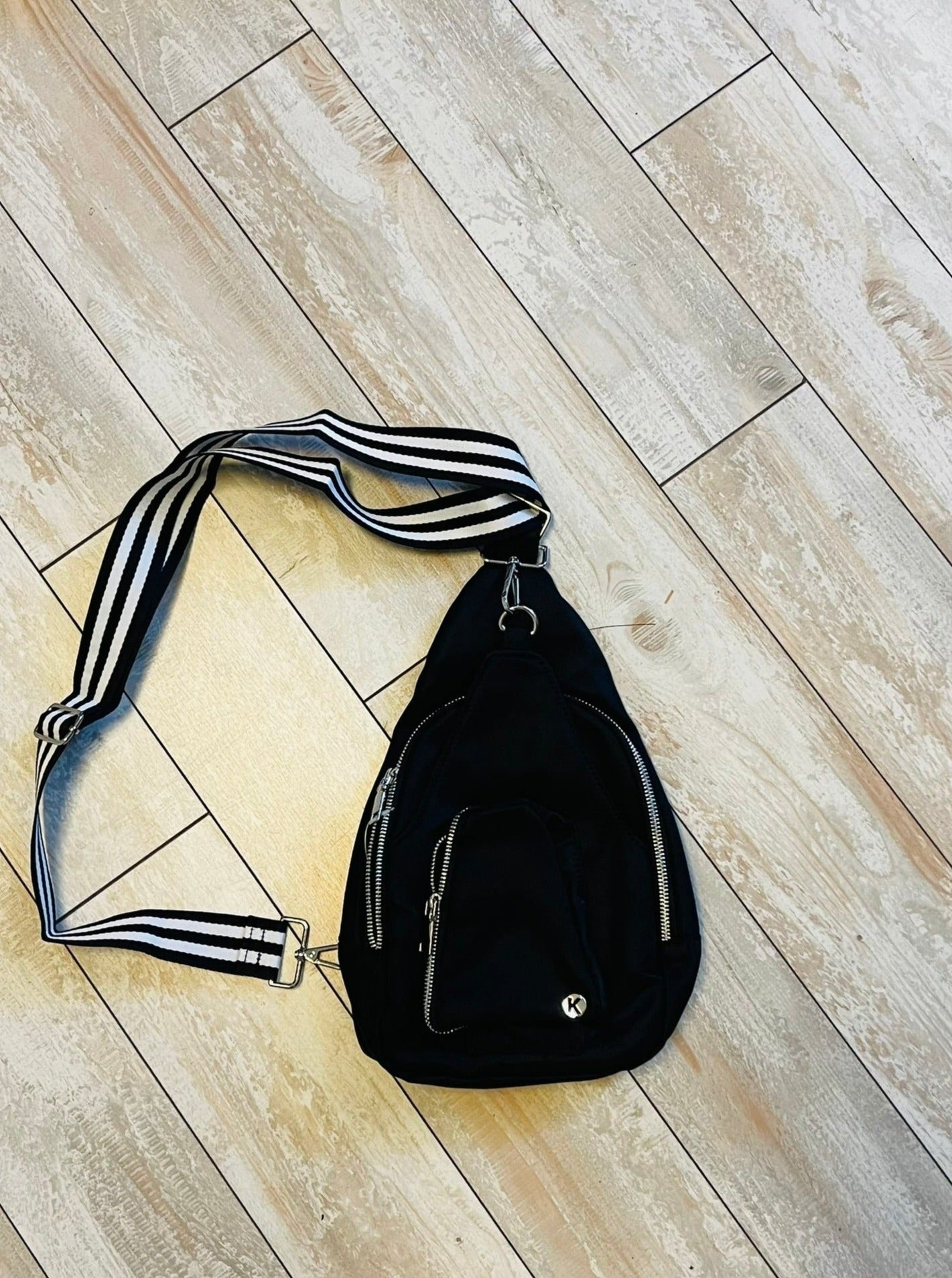 Sling bag with striped strap